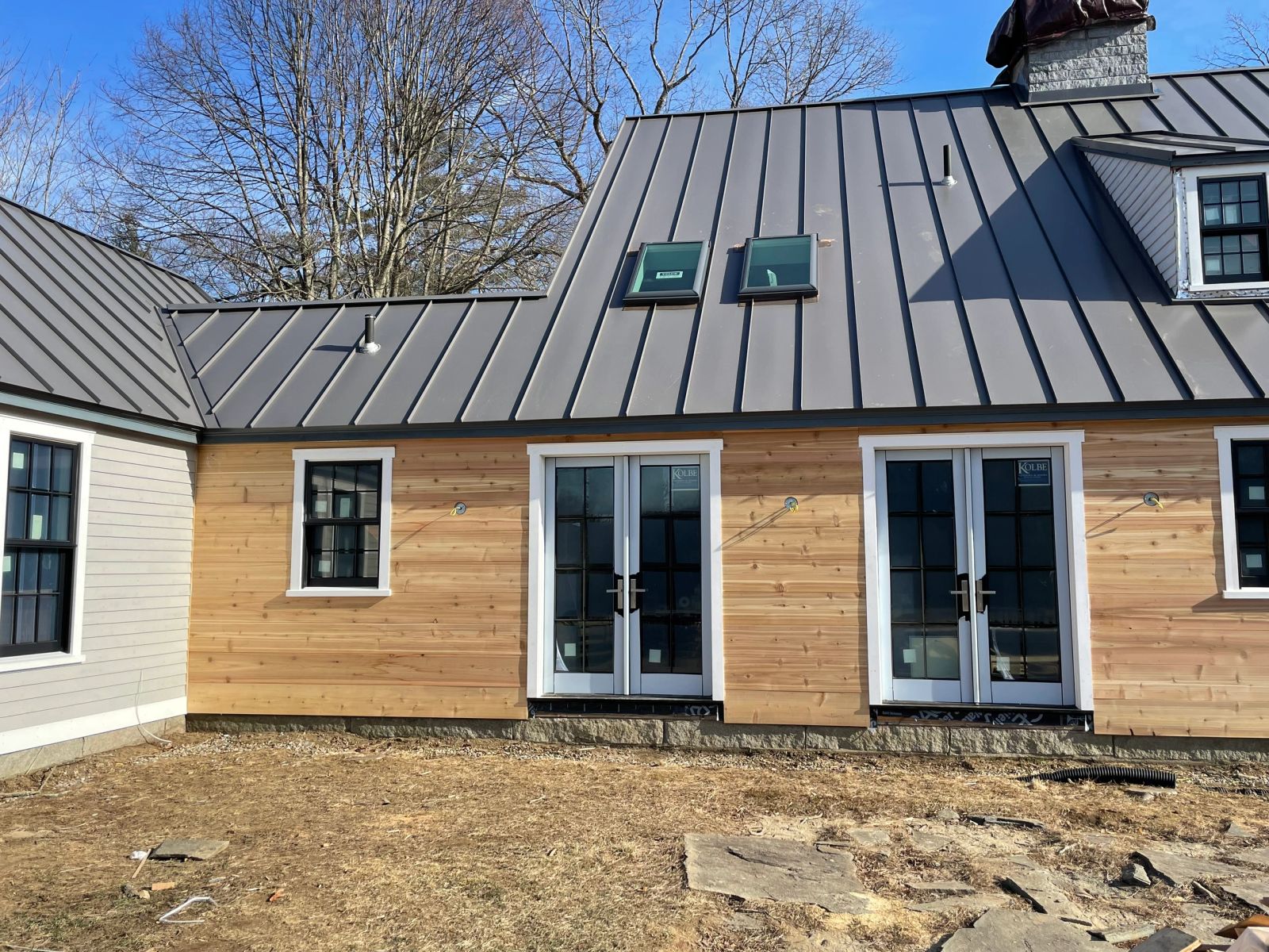 Home addition with cedar siding and metal roof